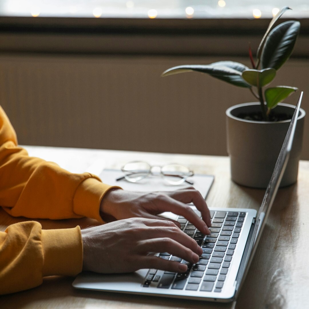 author typing on laptop